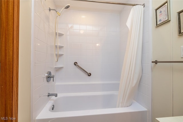 bathroom with shower / bath combo with shower curtain