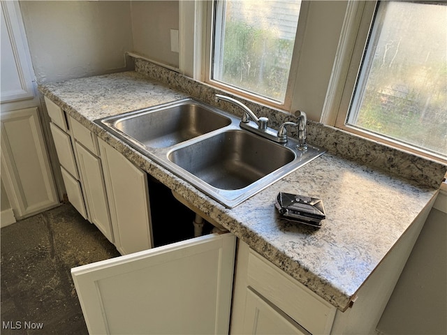 kitchen featuring sink, cream cabinetry, and plenty of natural light