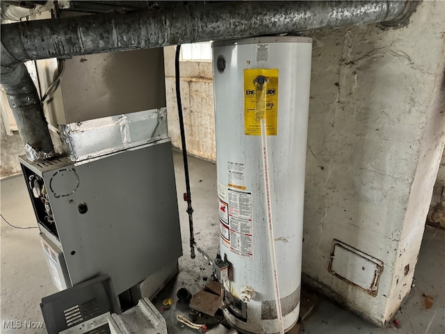 utility room featuring water heater and heating unit