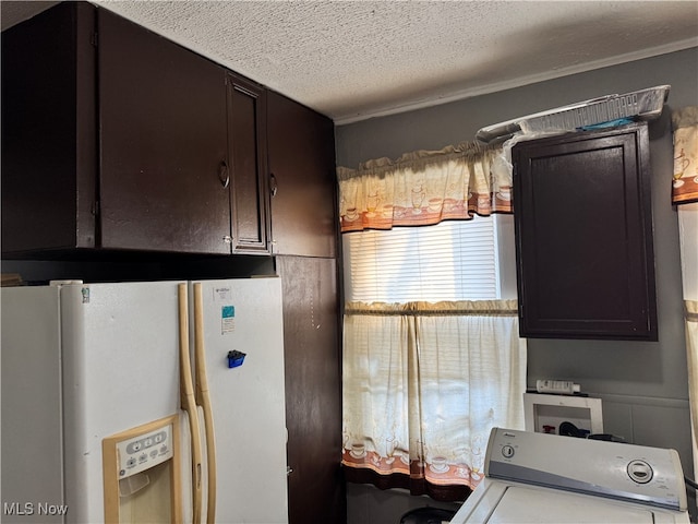 kitchen featuring dark brown cabinetry, a textured ceiling, washer / dryer, and white refrigerator with ice dispenser