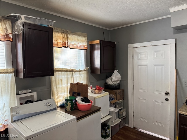 laundry area featuring cabinets, a textured ceiling, washer / dryer, crown molding, and dark hardwood / wood-style flooring