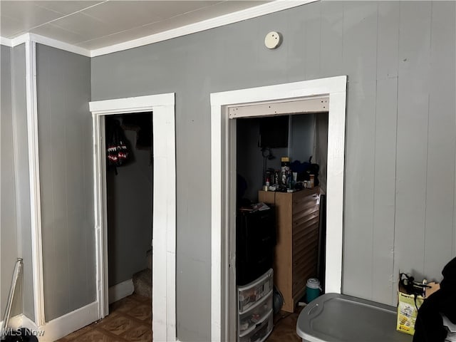 interior space featuring wood walls, parquet floors, and crown molding