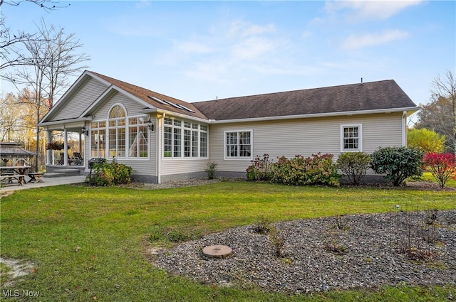 back of house with a lawn