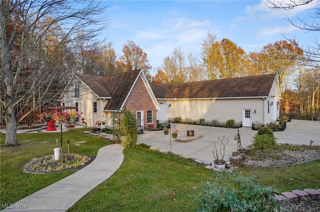 view of front of house featuring a front lawn and a patio area