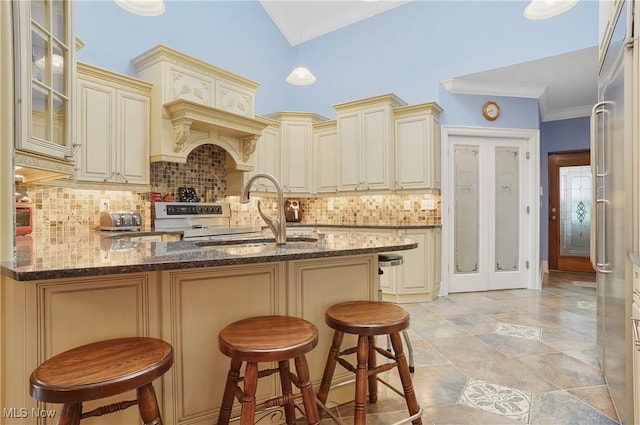 kitchen featuring a kitchen breakfast bar, cream cabinetry, and sink