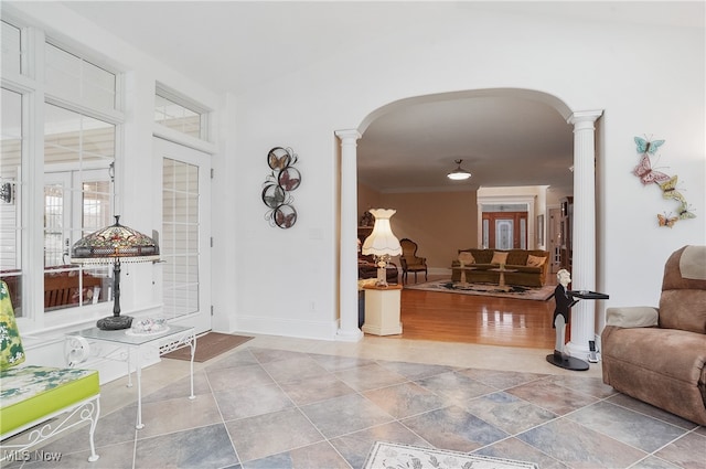 entryway featuring wood-type flooring, ornate columns, and french doors