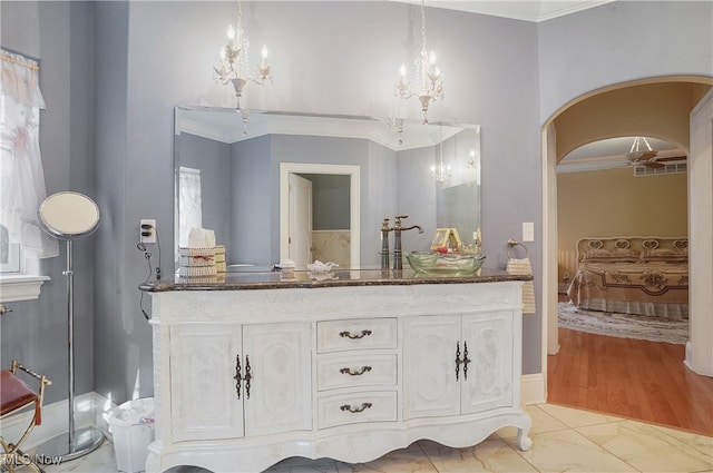 bathroom featuring ornamental molding and hardwood / wood-style flooring