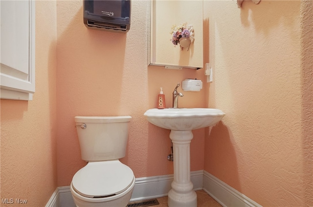 bathroom featuring toilet and sink