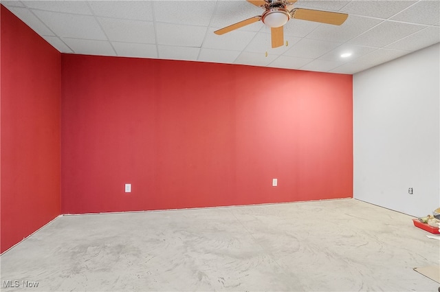 unfurnished room featuring a drop ceiling, concrete floors, and ceiling fan