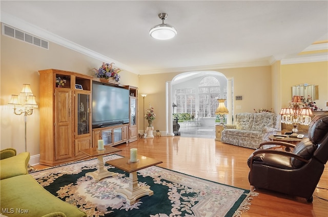 living room with ornamental molding and wood-type flooring