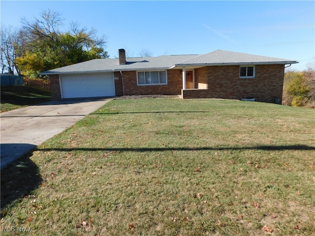 ranch-style home featuring a garage and a front lawn