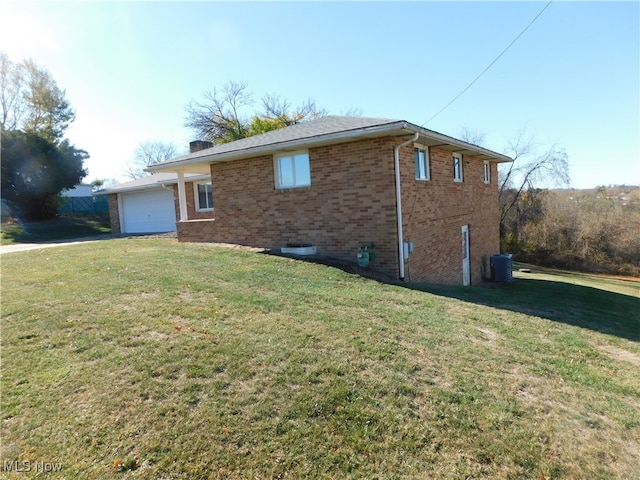 view of home's exterior with a garage and a lawn