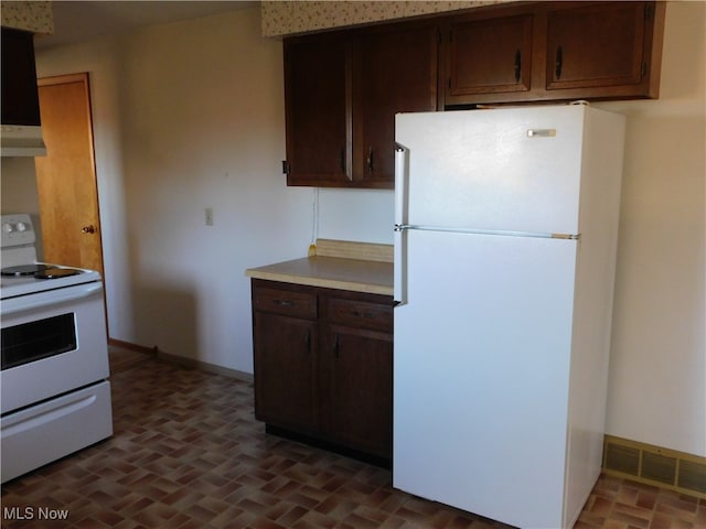 kitchen with dark brown cabinetry and white appliances