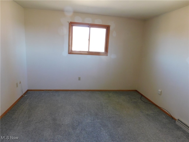 spare room with baseboard heating and carpet floors