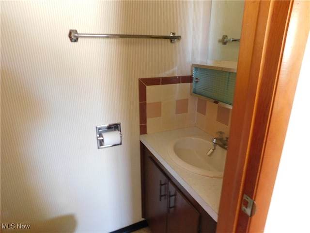 bathroom with vanity and decorative backsplash