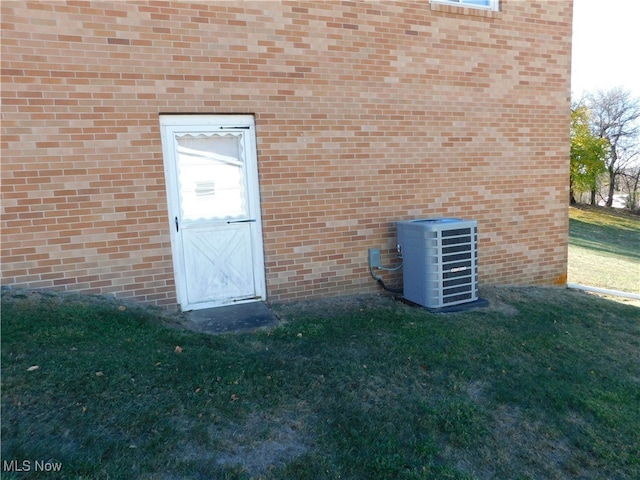 exterior space featuring a lawn and central AC