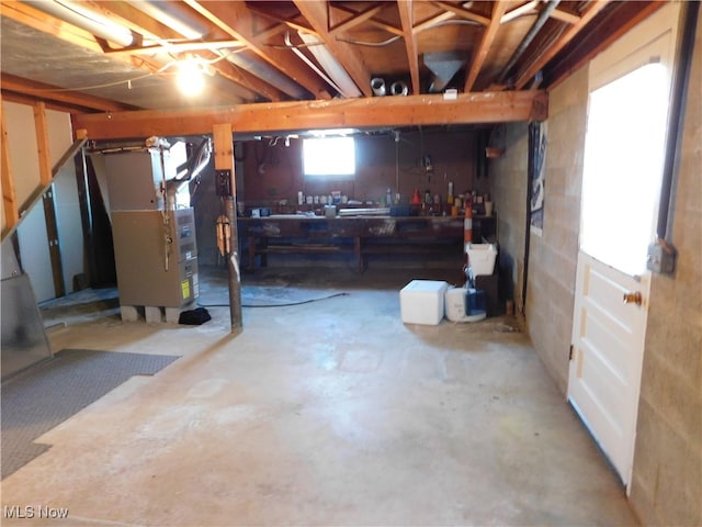 basement with a workshop area and heating unit