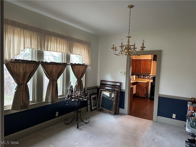 interior space featuring carpet floors, a healthy amount of sunlight, and a chandelier