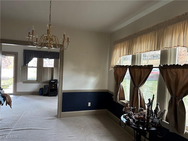 interior space featuring light colored carpet and a notable chandelier