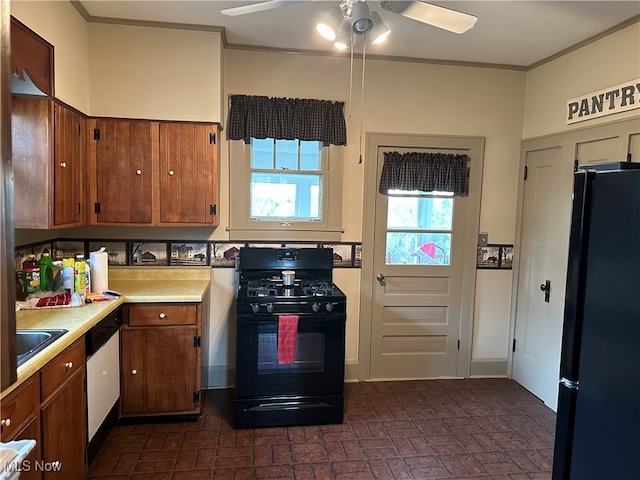 kitchen featuring ceiling fan, sink, black appliances, and crown molding