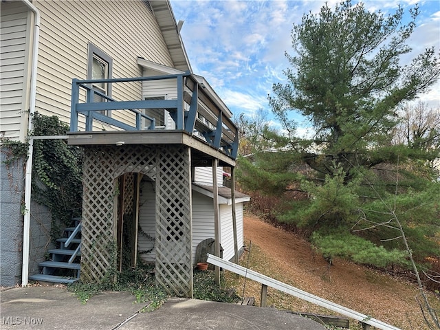 view of side of home with a balcony