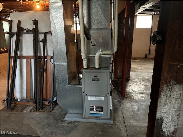 utility room featuring heating unit