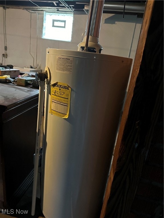 utility room featuring washer / dryer and water heater