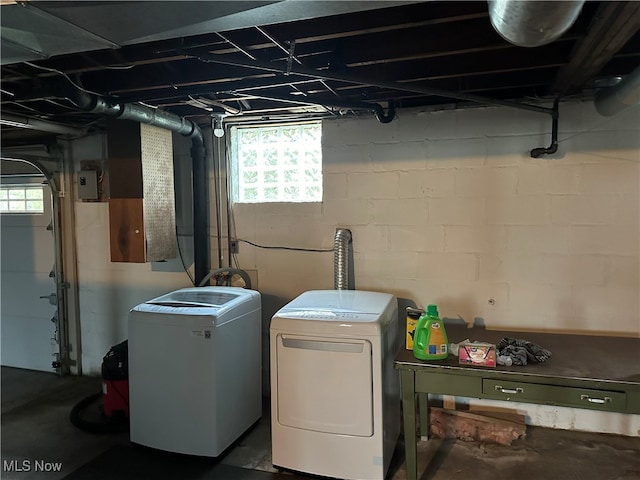 clothes washing area with a wealth of natural light and washer and dryer