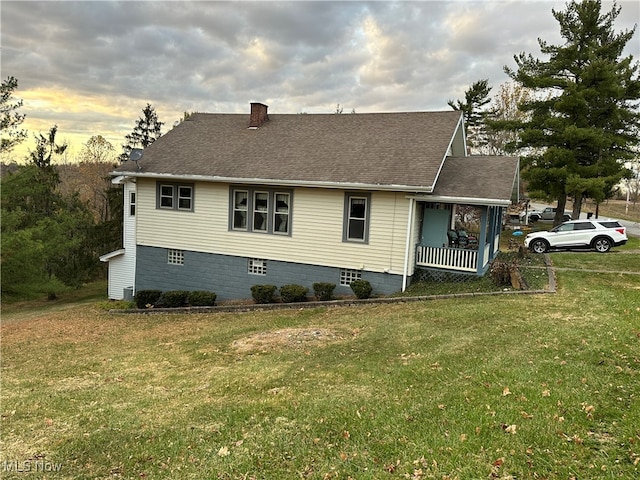 property exterior at dusk with a yard