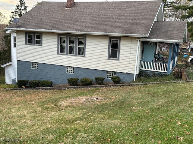 view of home's exterior featuring a yard and a porch