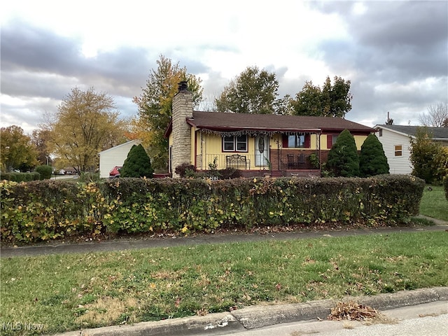 ranch-style house with a front lawn and a porch