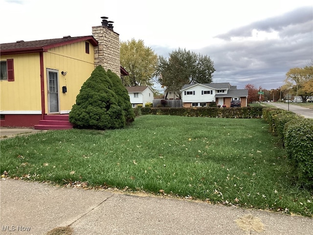 view of property exterior with a lawn