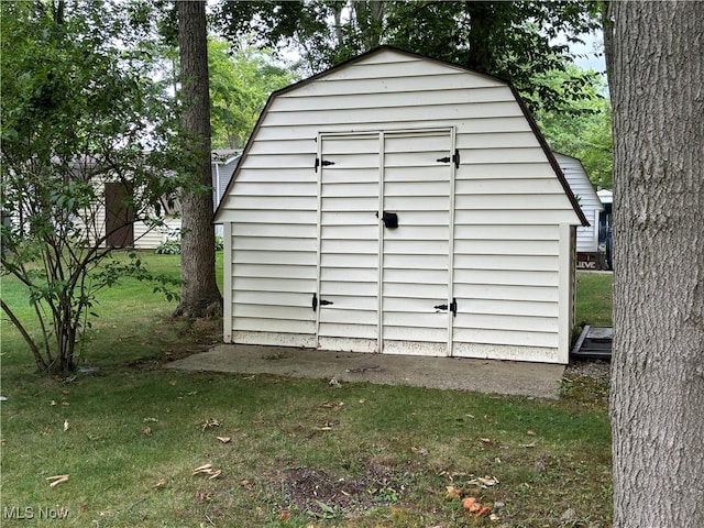 view of outbuilding featuring a lawn