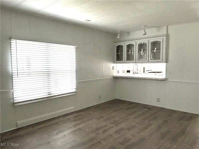 unfurnished dining area featuring dark hardwood / wood-style floors