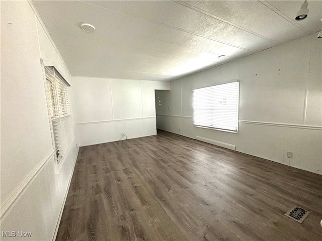 empty room featuring dark wood-type flooring