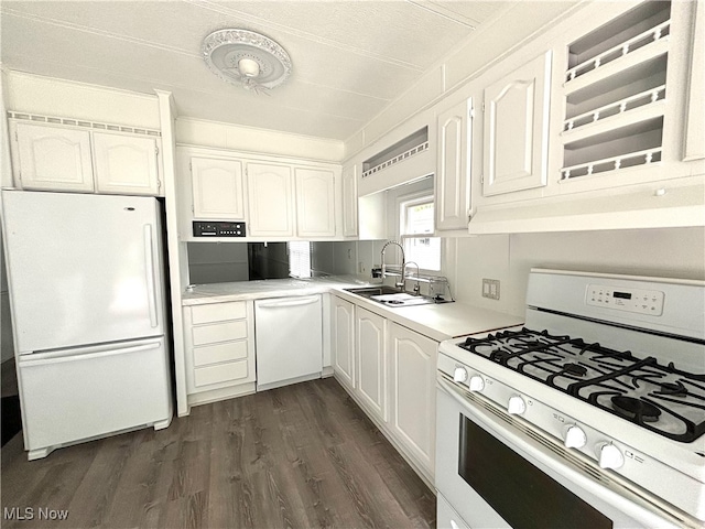 kitchen with a textured ceiling, dark hardwood / wood-style flooring, sink, white cabinets, and white appliances