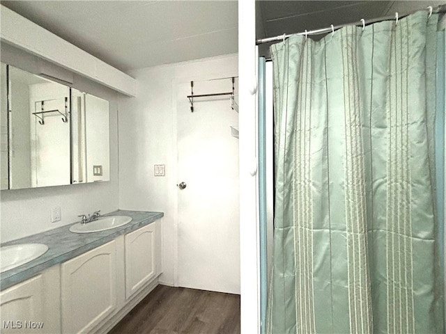 bathroom with hardwood / wood-style floors, vanity, and a shower with curtain