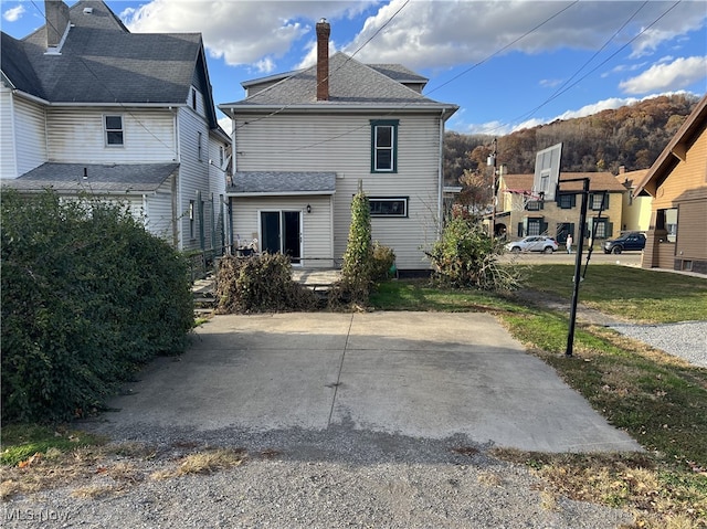 back of house with a lawn