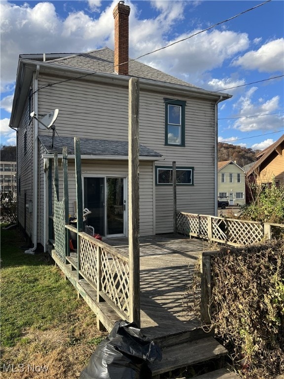 rear view of house with a wooden deck