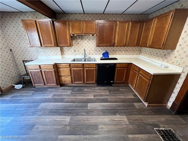 kitchen with dishwasher, dark wood-type flooring, sink, and a drop ceiling