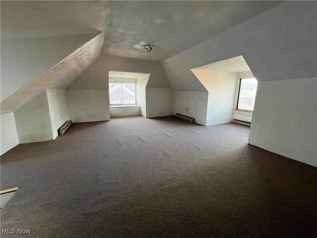 bonus room with a baseboard radiator, lofted ceiling, light colored carpet, and plenty of natural light