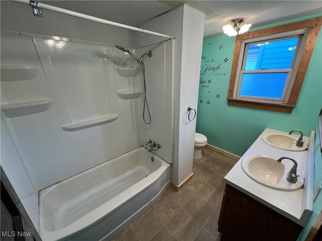 full bathroom featuring shower / tub combination, vanity, toilet, and a textured ceiling