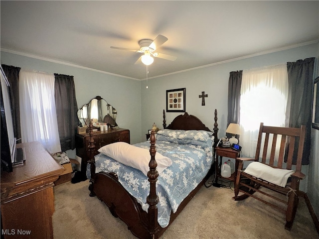 bedroom with multiple windows, crown molding, light colored carpet, and ceiling fan