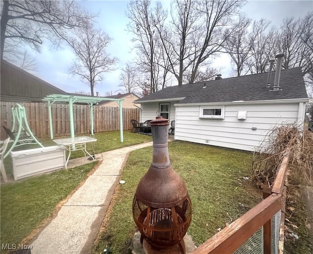 view of yard featuring a pergola and a fire pit