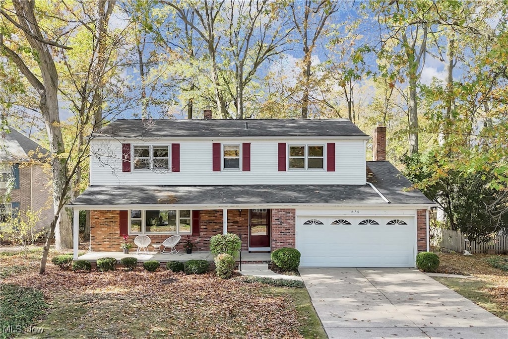 view of front property featuring a garage and covered porch