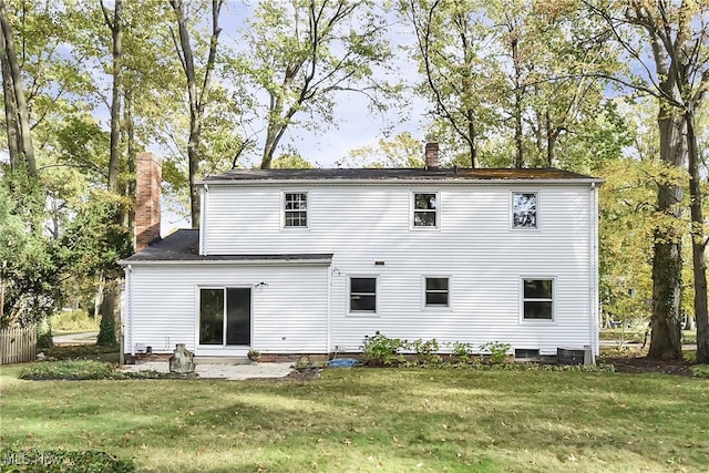 back of house featuring a lawn and central AC