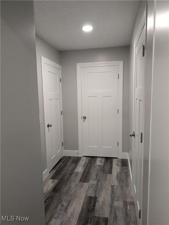 corridor featuring dark hardwood / wood-style floors