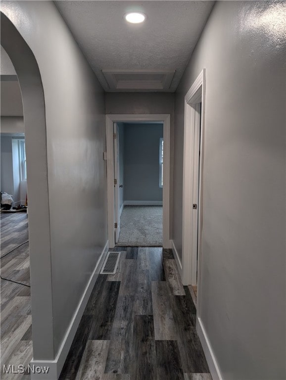 hallway with dark wood-type flooring