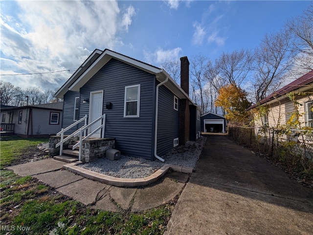 view of front of property with an outdoor structure and a garage