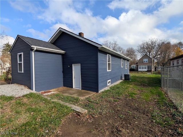 back of house with a yard and cooling unit